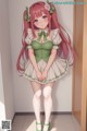 A girl with long pink hair wearing a green dress and green shoes.