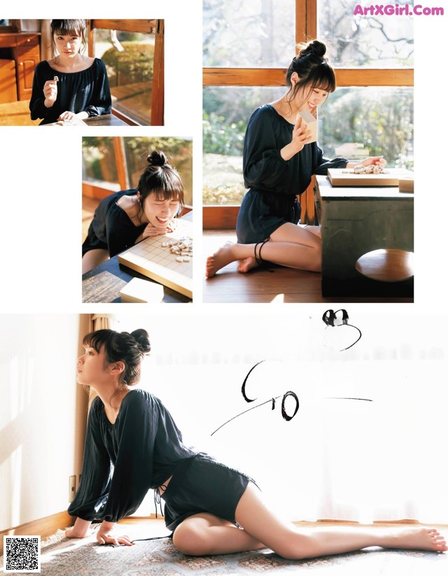 A woman sitting on the floor playing a game of chess.