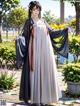 A woman in a long dress standing in a park.