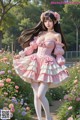 A woman in a pink dress standing in a field of flowers.